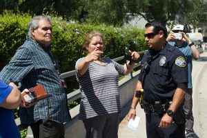 From left, Sacramento Jimenez and daughter Silvia Jimenez explain what happened to Officer Justin Cruz Monday, Aug. 28, 2017, on Cliff Drive near Santa Barbara City College. Silvia translated her fathers account of the five-car pile up.