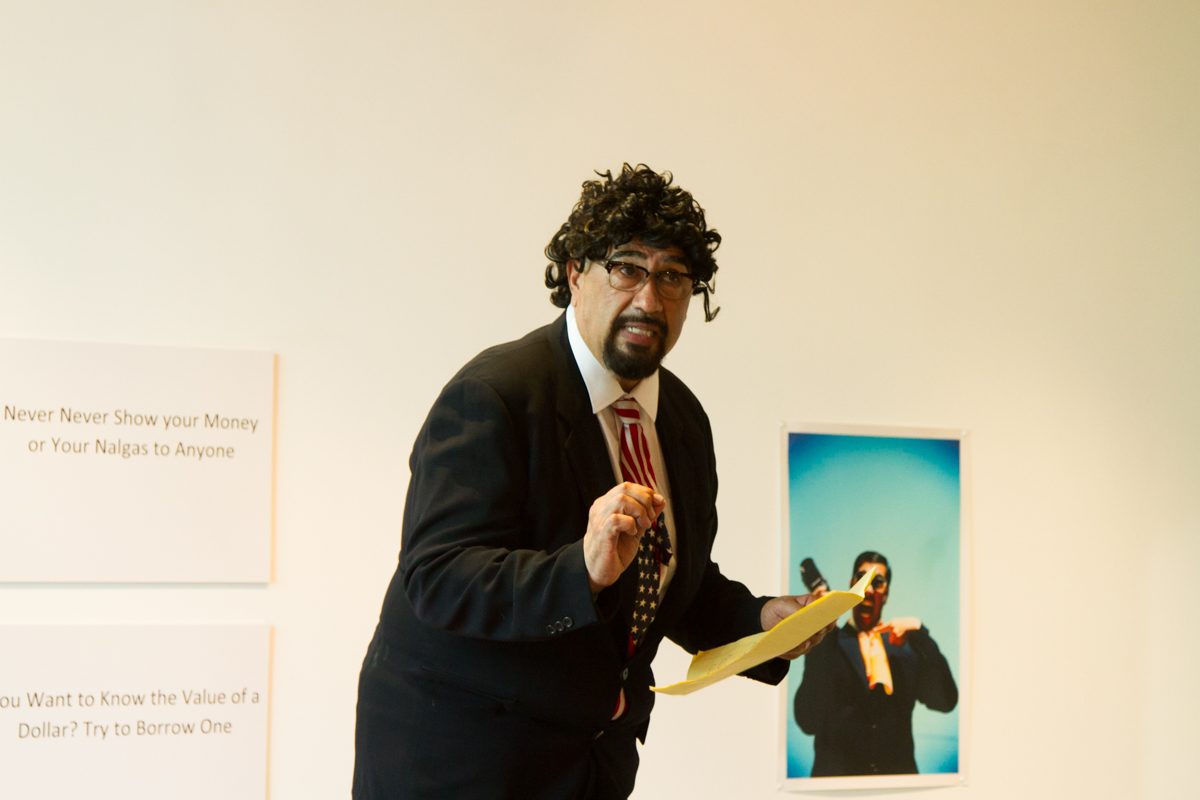 Tomas Carrasco performs a comedy act playing as a Chicano politician at his art show Thursday August 31, 2017 in the Atkinson Gallery. Carrasco is a professor at City College teaching Chicano Studies.