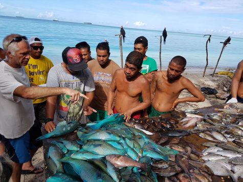 From left, Peter Nelson training fishermen from Elato Island in yap state of federated states of micronesia and on how to collect data on their fish catches.