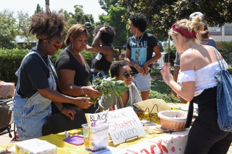 From left, Saturne Tchabong, J’Naer Bradford, and Tedenekialesh Debebe talk with a student about their club at Friendship Plaza in Santa Barbara City College, Santa Barbara, Calif. On Sept. 6, 2017. The Black Student Union recruits currently enrolled students who are interested in Black History.