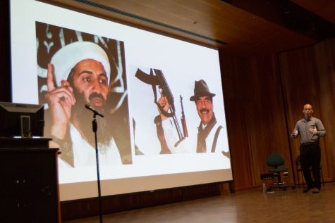 Philosophy lecturer and Religion professor Adam benShea giving a brief talk about fundamentalist terrorists during the “Religion and Violence” colloquium Thursday, Sept. 7 at the Fe Bland Forum in Santa Barbara City College. From left, his slide pictures extremists Osama Bin Laden and Saddam Hussain.