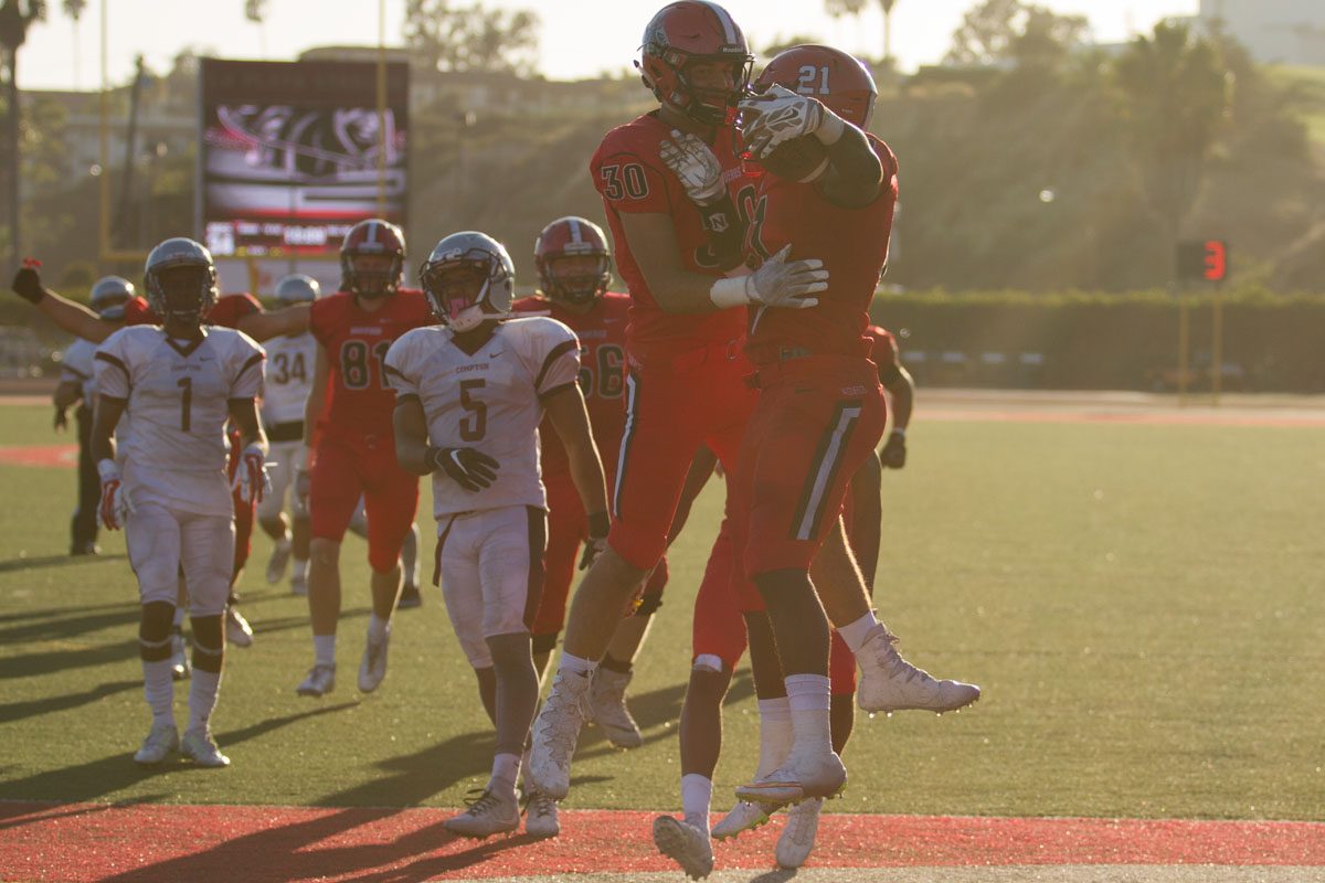 Running back Emmanuel Nwosu (No. 21) celebrating with teammate Cody Perry (No. 30) after scoring a touchdown against Compton College Saturday, Sept. 23., 2017, at La Playa Stadium in City College in Santa Barbara, Calif. Nwosus touchdown expanded the Vaqueros lead to 34-7.