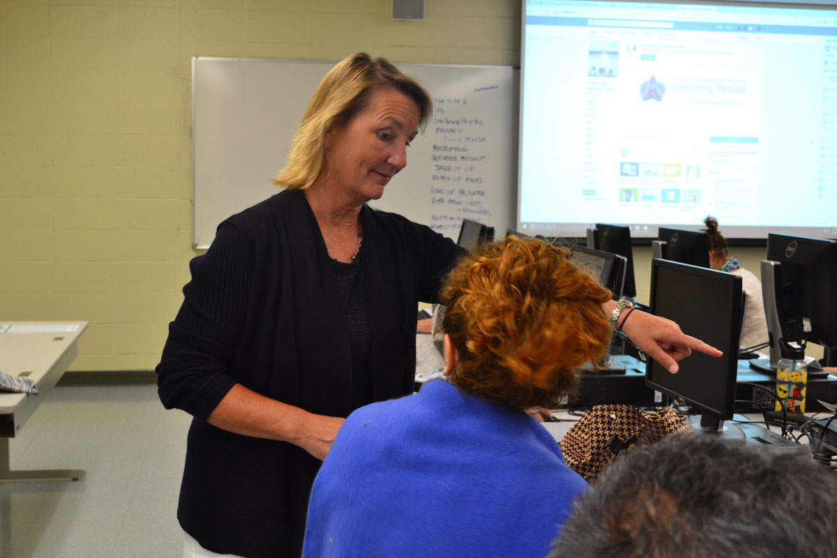 Linda Croyle, Career Skills Institute Instructor for the Extended Learning Program, goes around the classroom helping her Facebook for Business students Saturday Sept. 16 at Wake Campus Room 4 in Santa Barbara. This is one of Croyles weekly classes among her other tuition-free career skills courses.