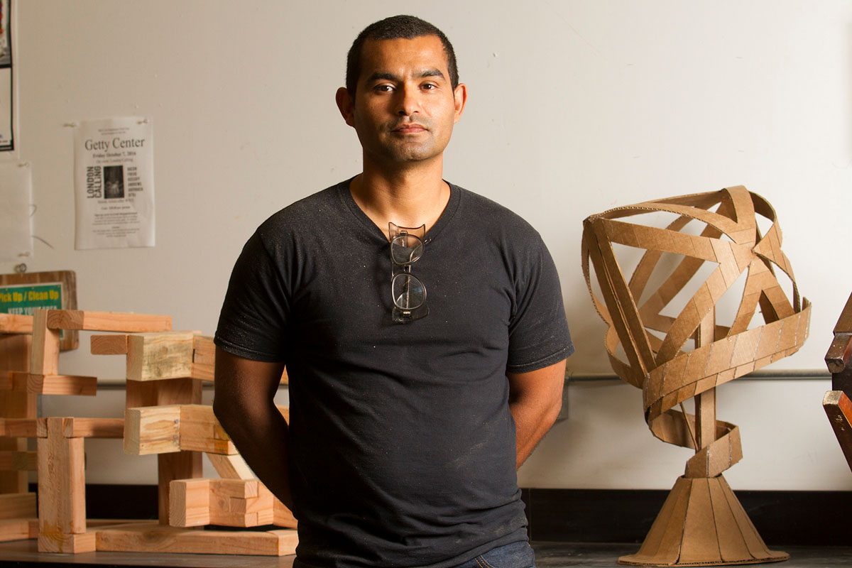 Dallas, Texas native Armando Ramos stands with student sculptures on Monday, Oct. 3, 2016, in his lab in the Humanities building at City College. City College Professor Ramos specializes in 3D sculptures made from all different types of material, such as wood and cardboard.