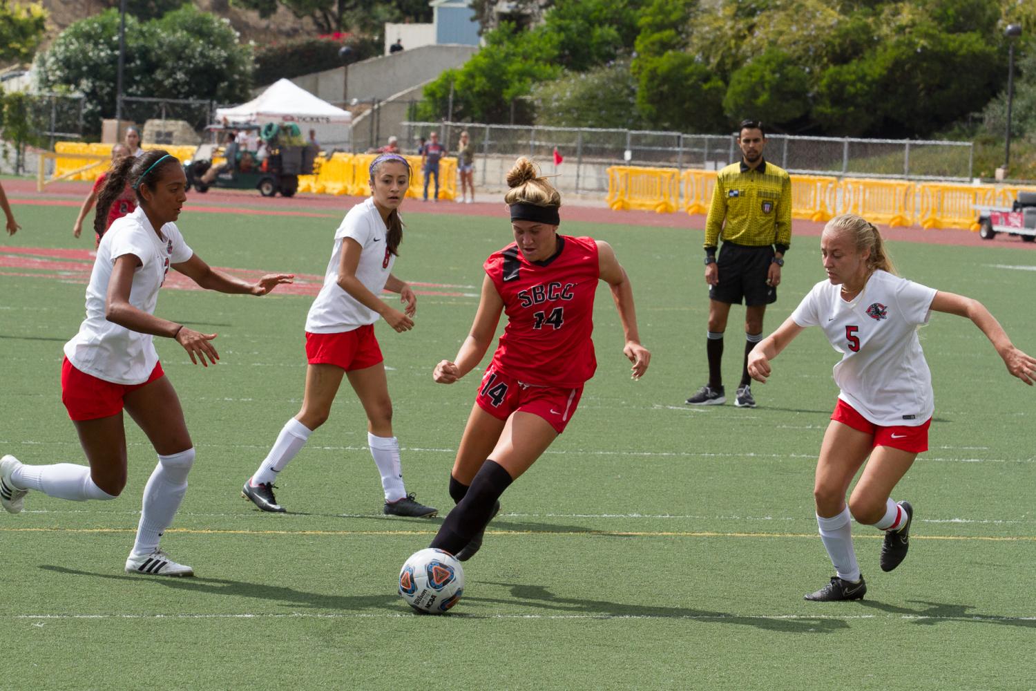 Forward Lourdes Gilbert runs the ball against Chaffey Colleges Emma Burgos (No. 3), Brianna Esquivel (No. 8) and Taylor Windham (No. 5) Tuesday, Sept. 19, at La Playa Stadium at City College. The Vaqueros won this game 2-0 and will play Victor College 2 p.m. Friday, Sept. 22 at Victor College.