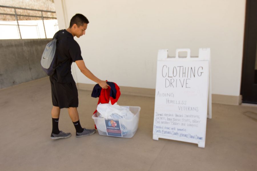 Andres Castro, Sophomore Track and Field sprinter, showing The Channels how easy it is to drop off clothes for the Clothing Drive Oct. 9 outside the Physical Equation building. The Santa Barbara County Veterans Stand Down and the City College athletic department partnered to create the clothing drive that will help homeless veterans in the community.