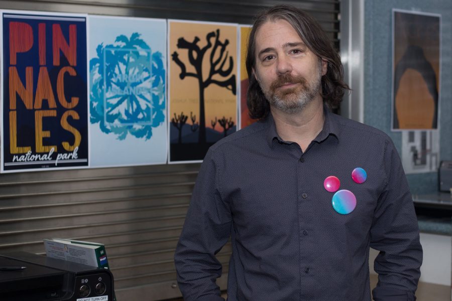 James Vanarsdale stands in his office with some of his students work Wednesday, Oct. 18, at City College. Vanarsdale is a Santa Barbara based graphic designer who was brought in to rebuild the graphic design program.