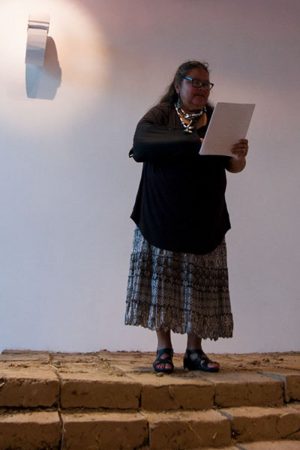 English teacher Annette Cordero recites two poems at the Day of the Dead poetry reading event.