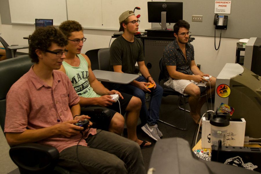 (From left) Club members Jacob Harms, Jake Hammond, Johnny Muhlenkamp and Will Yzaguirre focus as they play two separate Super Smash Bros. Melee matches Wednesday, Oct. 25, in Humanities Building Room 240. The Super Smash Bros. club brings their own gear from home including T.V.’s, consoles and controllers and set them up to practice for future competitions.