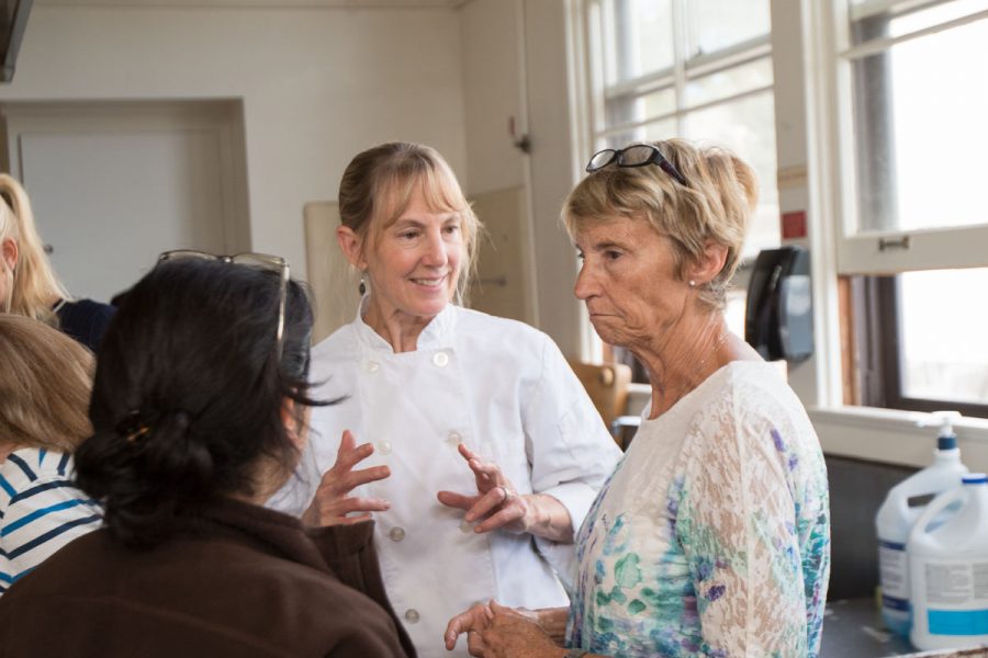 Diana Coburn, Easy Thanksgiving Side Dishes class Instructor, coaches Yolanda Figueroa and Barbara Evanish Wednesday afternoon, Nov. 15 at the Culinary Lab in Schott Campus. Coburn is a cooking instructor and a professional caterer.