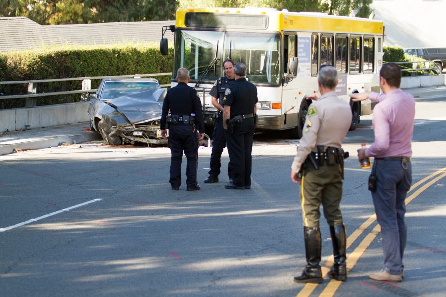 Santa Barbara Police Department investigates a vehicle collision on Wednesday, Nov. 29, 2017, west of the intersection of Cliff Drive and Rancheria Street. Officers (from left) Scott Naganuma, Carl Kamin, Sergeant Dan Tagles, Senior Deputy Sheriff Jeff Farmer, and Traffic Investigator Ethan Ragsdale discuss details about how the incident occurred.