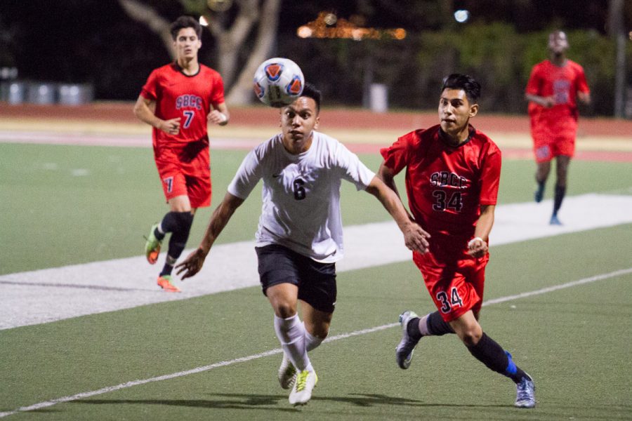 City College forward Celso Lagunas (No.34) works to keep control of the ball late in the game against Fernando Ramirez, San Bernardino Valley College Wolverine midfielder (No. 8), Saturday, Nov. 18 at La Playa Stadium. The Vaqueros won the first round of the SoCal Regional Playoffs in the Western State Conference.