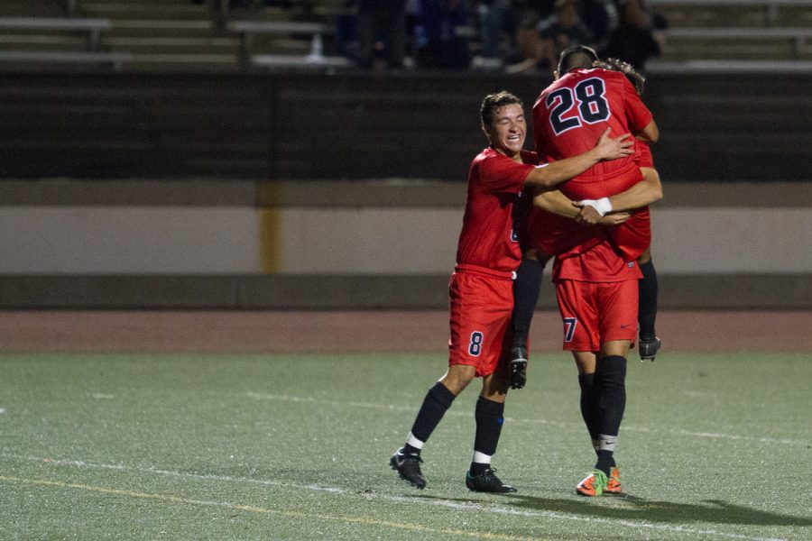 City College midfielder Adrien Gamez (No. 28) celebrates his game winning goal with teammates, Carlos Espinoza (No.7) and Jessie Jimenez (no.8), late in the game against San Bernardino Valley College Saturday, Nov. 18, at La Playa Stadium.