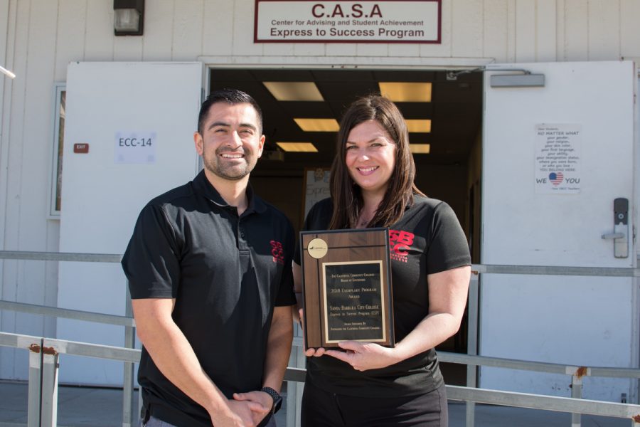 AAndrew Gil (left) and Cosima Celmayster-Rincon holding the California Community Colleges Board of Governors Exemplary Program Award honoring the Express to Success Program at Santa Barbara City College in Santa Barbara on Thursday, Feb. 15. Gil has been with the Express to Success program for two years and Celmayster-Rincon has been with the program for seven years.
