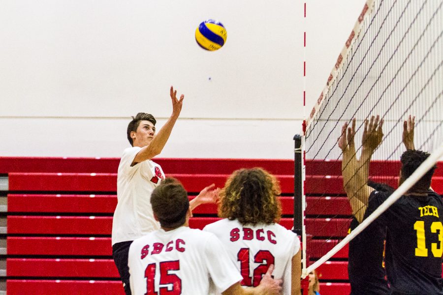 Kyle Skinner (No.14) pokes the ball over the Los Angeles Trade-Technical College defense on Feb. 21, at the Sports Pavilion, in Santa Barbara. “My passing was pretty good, but not as good as I wanted it to be,” Skinner said after the Vaqueros dominated LA in 3 sets.