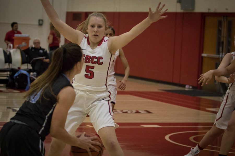 Maaria Jaakkola (no. 5) tries to stop Emily Herring from earning another point. Raiders won the game 70-56 at the City College Sports Pavilion Wednesday, Feb. 14.