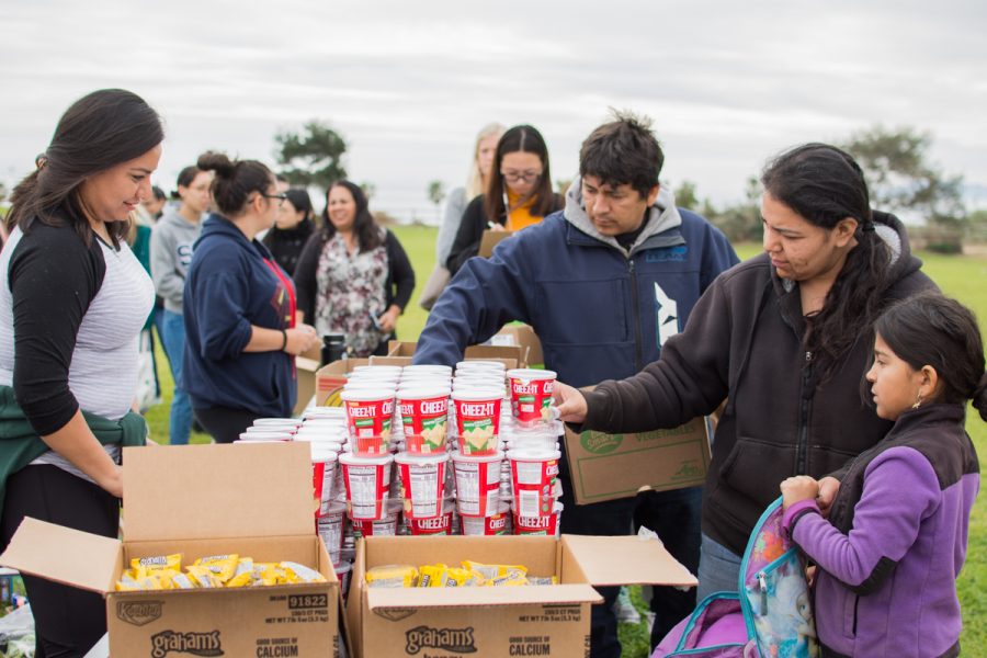 Karina Galaviz and daughter Eileen Galaviz get a snack during the food share held on Wednesday, March 7, at the West Campus Lawn at Santa Barbara City College.