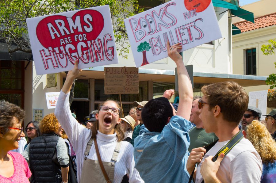 Eva Beebe(Left), and Stella Moore chant and raise their signs during the March For Our Lives protest on Saturday at De La Guerra Plaza in Santa Barbara. March For Our Lives protesters stand in solidarity with the survivors of the Stoneman Douglas High School massacre in honor of the kids and teachers who died there and in support of all students who fear for their lives.