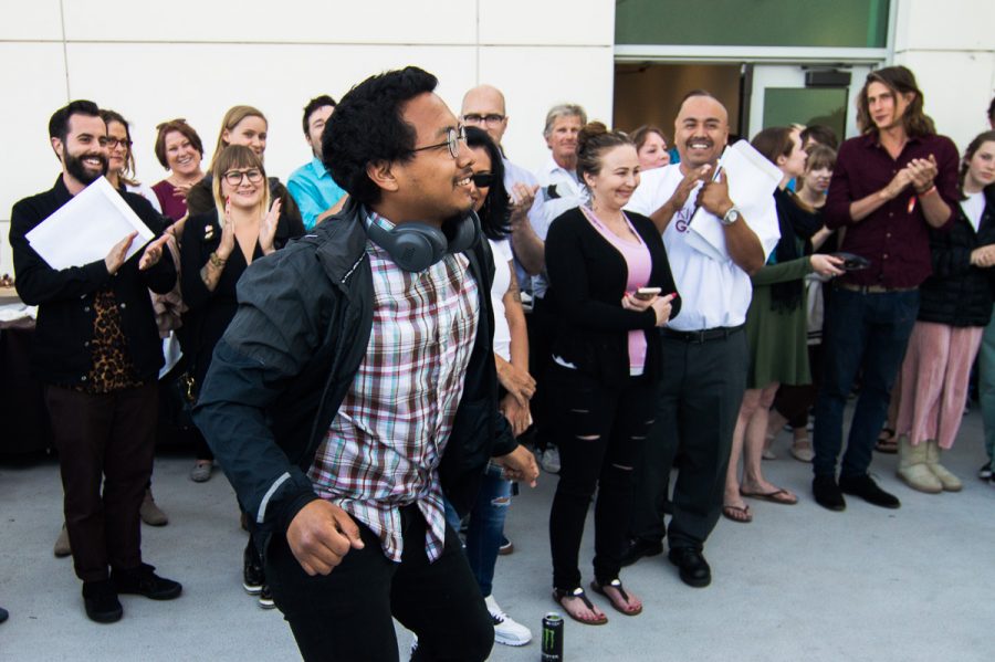 Alejandro Martinez dances his way up to receive his scholarship award at the Atkinson Gallery. Martinez received $4,500 for the Eli Luria Honorary Scholarship in Studio Art.