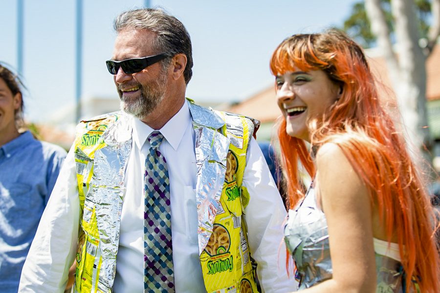 Superintendent/President Anthony E. Beebe tries on his new suit vest made of Funyun bags on Thursday, at the Earth Day gathering at City College. The vest was presented by Frances Manthrope after the Trashion Show, where students wore attire made of repurposed materials.