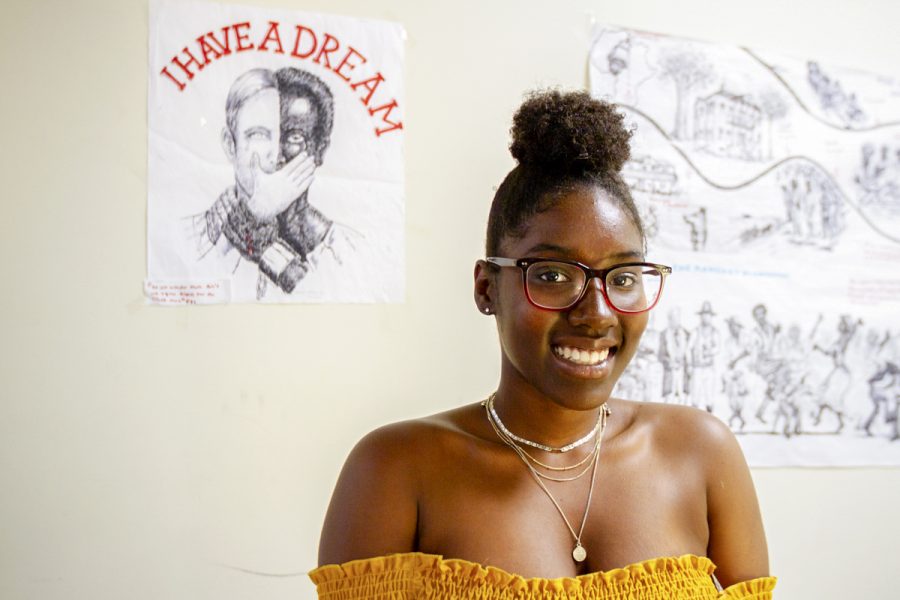 Tiffany Love in front of artwork displayed in Campus Center Room 226 on Tuesday, May 1, at Santa Barbara City College. Love is a member of the Black Student Union, and recently was accepted into the UCSB Smithsonian Scholars Program, which will take her to Washington D.C. this summer. Love, a biology major, is starting a club at City College called Society of Black Scientists and Engineers.