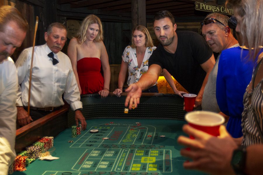 Gio DiPoalo throws the dice on the craps table on Sunday, May 6, at the Carriage Museum near Pershing Park. The craps table was crowded most of the evening.