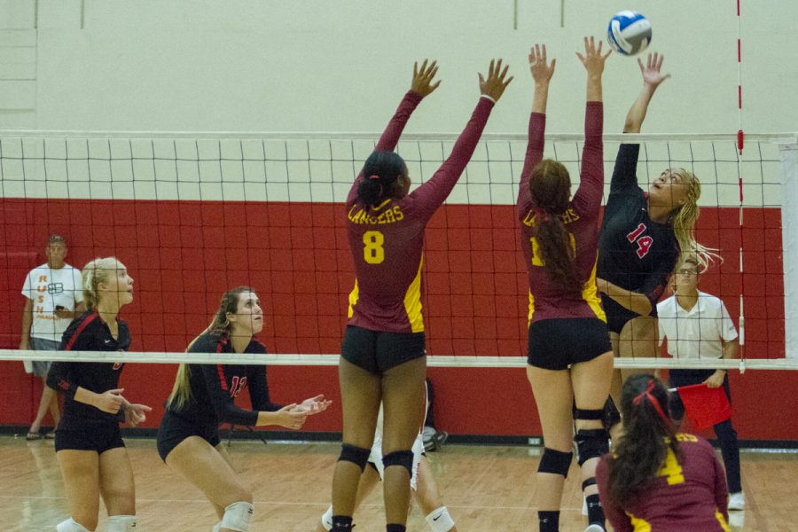 City College outside hitter Jazz Hill (No. 14) attempts a spike against Pasadena City College middle blockers Jada O’Mally (left, No. 8) and Rachel Johnson (No. 16) at the Sports Pavilion gym at City College in Santa Barbara, Calif., on Saturday, Sept. 8, 2018.
