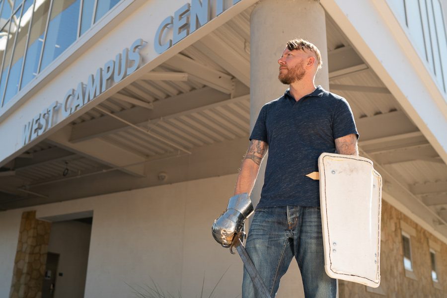 Professor Mark Sanders poses with a medieval melee weaponry in front of the West Campus Center at Santa Barbara City College on Tuesday, Sept. 18.