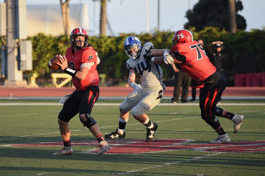 City College quarterback Gerald Hickson (No. 2) attempts a pass while Ramon Lazarit (No. 75) blocks Zach Stauffer (No. 44) of San Bernardino Valley at La Playa Stadium at City College in Santa Barbara, Calif., on Saturday, Sept. 8. The Vaqueros lost to the Wolverines 35-13.