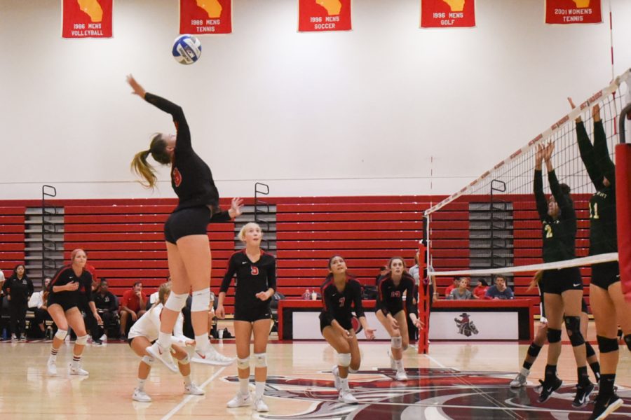 Kate Willingham (No. 8) spikes the ball against Grossmont Community College at the Sports Pavilion gym at City College on Saturday, Sept. 22.