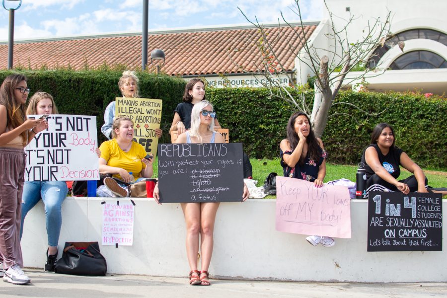A group of City College students holding signs stand across from Project Truth, a pro-life group that aims to “educate students on the injustices of abortion” according to one of the members, at the West Campus at City College in Santa Barbara, Calif., on Tuesday, Oct. 2, 2018. The students were trying to get people to sign a petition to remove the graphic photos that Project Truth have set up.