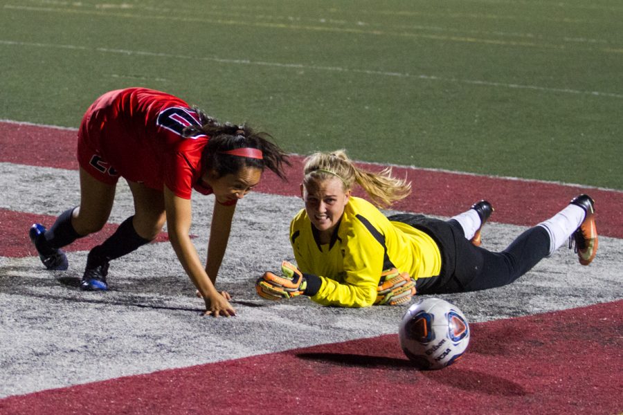 City College forward Alejandra Alvarez (No. 20) attempts to steal the ball from Cuesta College goalkeeper Brenae Damery (No. 0) at La Playa Stadium on Tuesday, Oct. 16, 2018, in Santa Barbara, Calif. Damery had a total of 16 saves that game, but the Lady Vaqueros still defeated the Cougars 2-0.