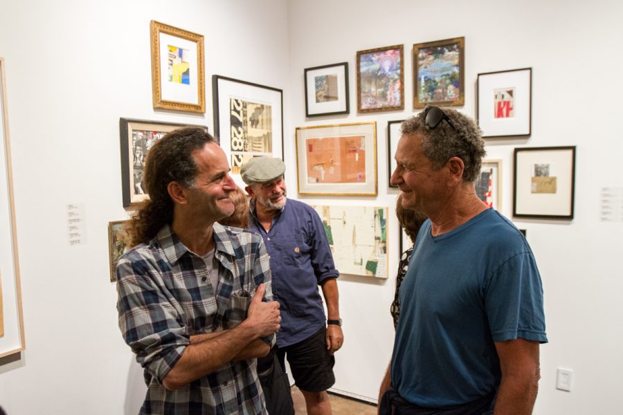 Tal Avitzur (left) speaks with Jerome Mercer (right) during The Red-Headed Stepchild: The History of Collage and Assemblance event at the Sullivan Goss Gallery in Santa Barbara, Calif., on Thursday, Oct. 4, 2018. Avitzur is currently a math professor at City College.