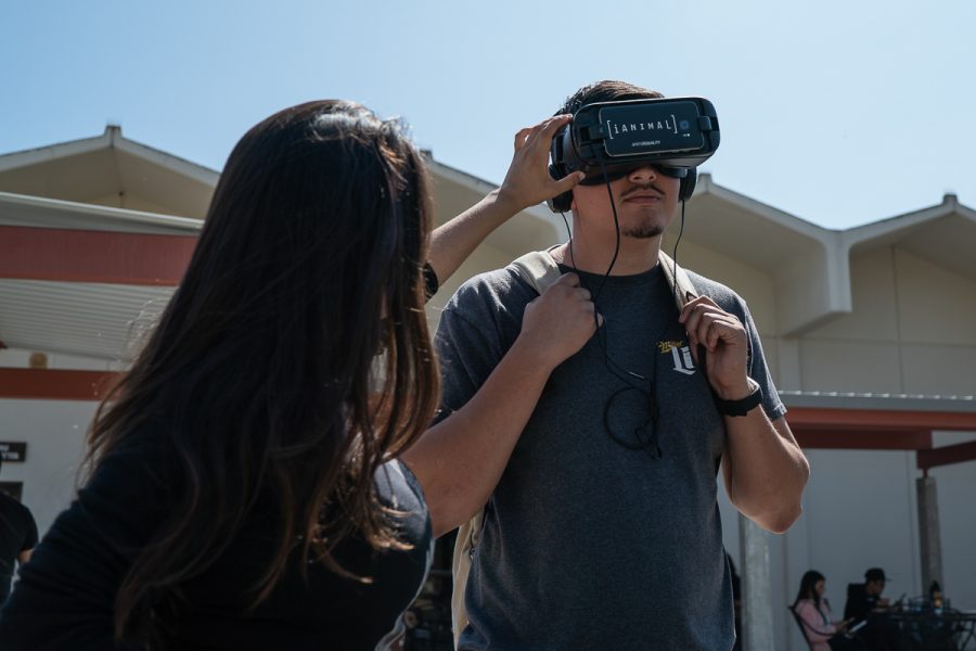 Alicia Alcasas helps a student start a virtual reality experience where the viewer is placed in the slaughterhouse assembly line with the livestock at City College in Santa Barbara Calif., on Monday, Sept. 24, 2018. The VR headset experience was part of the Animal Rights Club event.