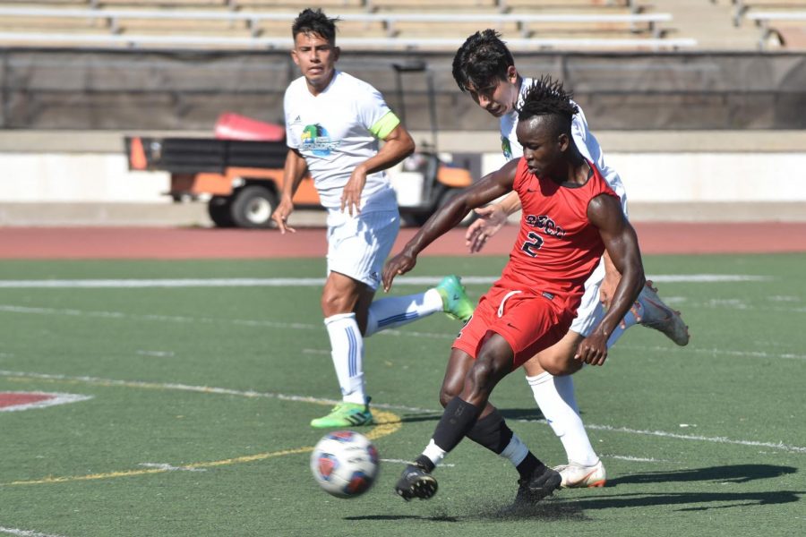 Oxnard College players follow close behind City College player Ameyawu Muntari (No.2) as he passes the ball on Tuesday, Oct. 30 at Santa Barbara City Colleges La Playa Stadium. The Condors and Vaqueros tied 1-1.