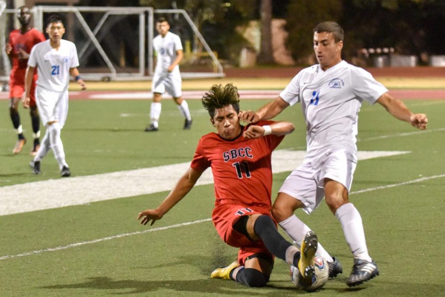 City College player Celso Lagunas (No. 11) slides to block the ball from Santa Monica college player Yoel Cohavy (No. 11) on Tuesday, Oct. 23, 2018, at La Playa Stadium at Santa Barbara City College, in Santa Barbara Calif. The Corsairs defeated the Vaqueros 1-0, scoring a goal in the 90th minute.