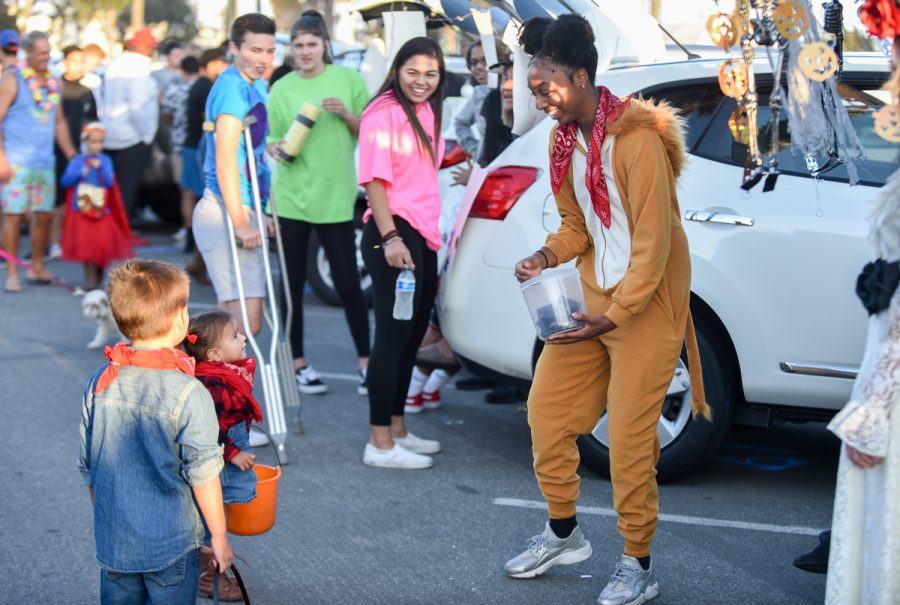 Megan Moore, dressed up as lion, passes out candy to Mila Boardman during the second annual Trunk or Treat event held at the parking lot adjacent to La Playa Stadium on Friday, Oct. 26, at City College in Santa Barbara Calif. The free event was hosted by the City College Athletic Department to give children a safe place to trick-or-treat.