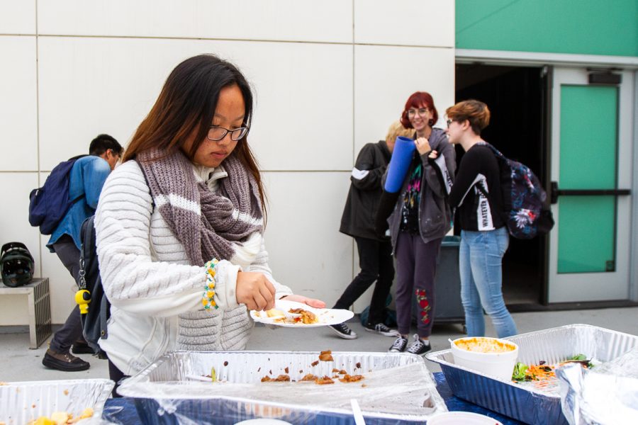 Valerie Moua serves herself food at the club mixer the Associated Student Senate arranged on Monday, Nov. 19, at the Atkinson Gallery at City College in Santa Barbara, Calif. The club mixer offered free food, and students had the chance to meet new people and find clubs to join.