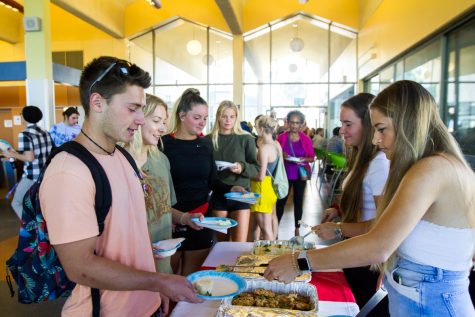 Florentina Lang serves Pierre Fumat pork with mashed potatoes, an Austrian dish, at the annual International Food and Culture Fair hosted by the City College Ambassadors on Friday, Nov. 16, at the East Campus cafeteria at City College in Santa Barbara, Calif.