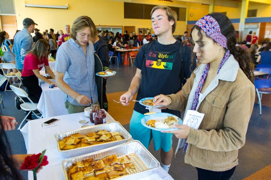 From left, Francesco Velez-Quilici, Eric Thornburgh, and Jasmine Salik serve themselves Finnish pancakes at the annual International Food and Culture Fair hosted by the City College Ambassadors on Friday, Nov. 16, at the East Campus cafeteria at City College in Santa Barbara, Calif. The Finnish dish, also known as pannkakku, is made in the oven and usually for dessert.