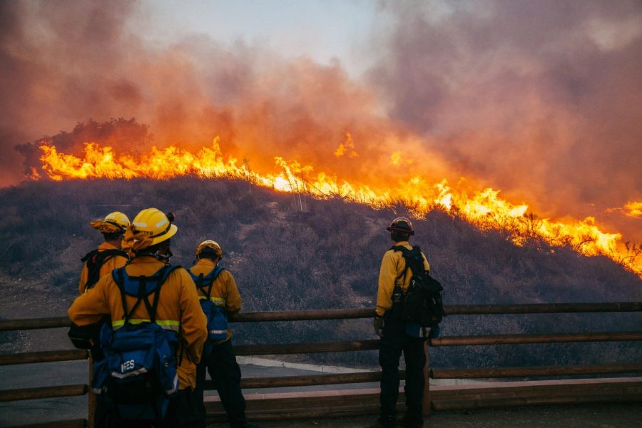 Fire Fighters from the Orange County Fire Authority battle the Woolsey Fire as it burns the hillside near West Lake High School on Friday, Nov. 9, 2018, in Thousand Oaks, Calif. Roughly 75,000 homes in both Ventura and Los Angeles counties have been evacuated.