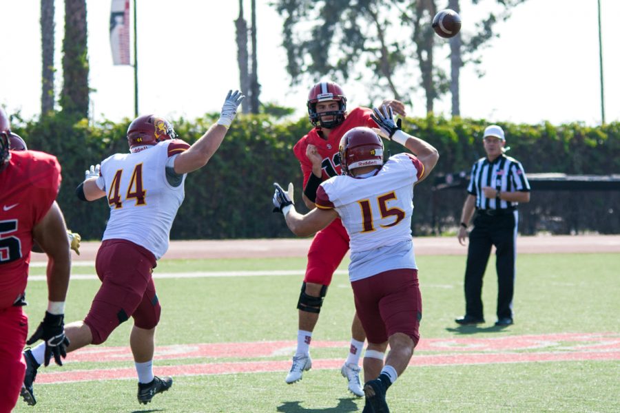 Vaquero Franco De Luca passes the football before Pasadena City College’s defensive linemen David Vardanian (No. 44) and Hector Palacios (No.15) make the tackle on Saturday, Nov. 10, 2018, at La Playa Stadium in Santa Barbara, Calif. De Luca passed the ball to Nick Foster for a 43-yard touchdown to make the first score of the game.