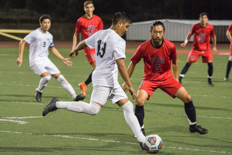 Takahiro Fujii (No. 5) keeping his eyes on the ball as Moorparks Ernesto Alvarado (No. 13) drives the Raiders down field in an attempt to score their first goal on Friday, Nov. 2, at La Playa Stadium in Santa Barbara, Calif. The Vaqueros cruised their way to a victory, defeating the Raiders 6-1.