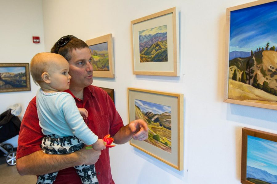 Matt Kay and his son Wren Kay look at artwork displayed during the Oak Group’s exhibition ‘In Wildness’ on Jan. 25, 2018, at City College’s Atkinson Gallery in Santa Barbara, Calif. The gallery featured landscape paintings by members of the Oak Group.