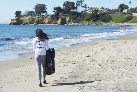 Phi Theta Kappa Vice President of Service Layla Tondravi walks the beach looking for trash during their beach clean up event on March 9, 2019 at Leadbetter Beach in Santa Barbara, Calif.