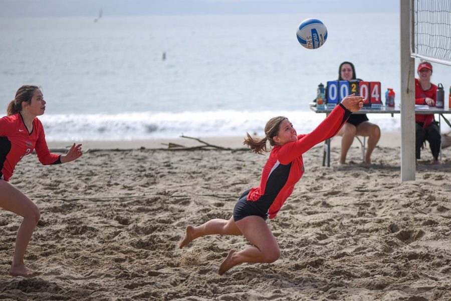 Maddie Meyer (No. 4) dives to save the ball with Michelle Orgel (No. 3) following close behind on Friday March 1 at East Beach in Santa Barbara.