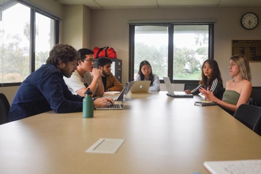 From left, professor Mark Bobro and students, Seine Ham, Jorge Caballero Naranjo, Zongchan Chen, Myrth Tan and Anna Love prepare for the “International Business Ethics Competition” in the Luria Library.