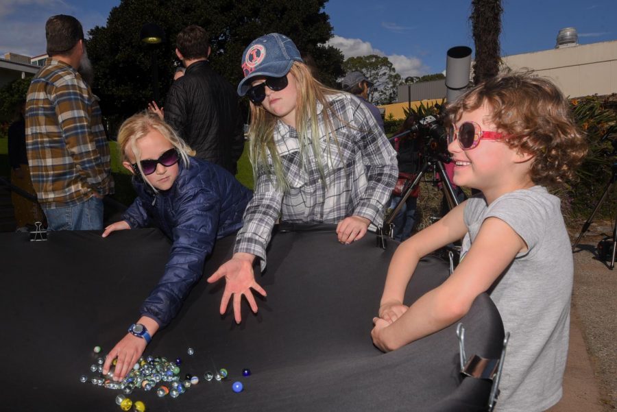 From left, Marlee Cattanach, Delany Hansen, and Emma Clarke experiment with a black-hole replication telescope at the “Science Discovery Day” on Saturday, March 8, 2019, on East Campus at City College in Santa Barbara, Calif.