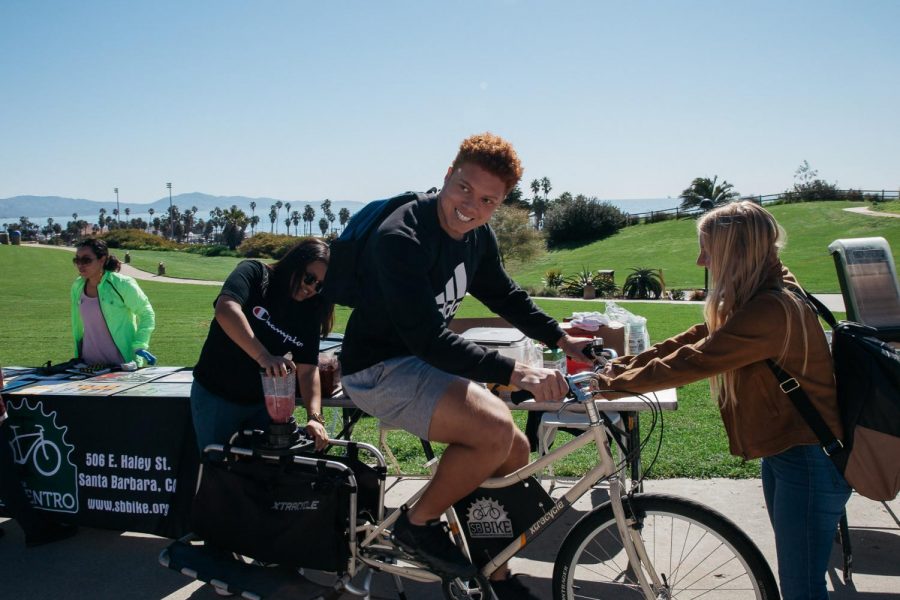 Isaac Brown pedals a blender bike to make an energy efficient smoothie during sustainability day on Thursday, March 14, 2019 on west campus at City College in Santa Barbara, Calif. The bike, provided by Bici Centro, uses the power from pedaling to spin the blender blades and make free smoothies for students to encourage biking to burn less fossil fuels.