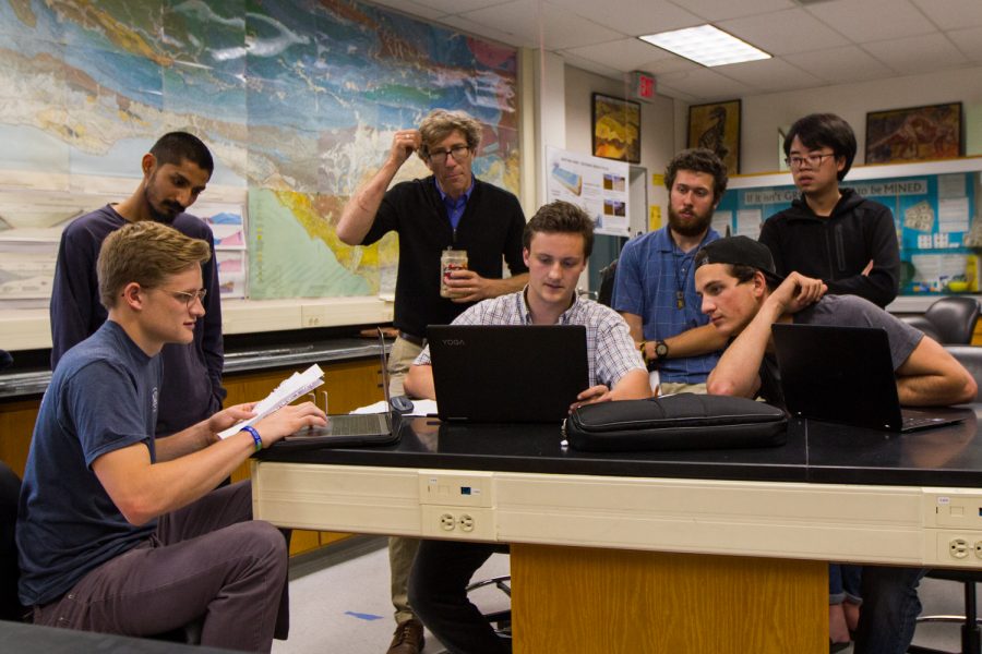 From left, Bryce Mather, Joneel Zinto, Bill Dinklage, Weston Ferrell, Zachary Gundrey, Brandon Reedel, and Craig Xie discuss plans for setting up a solar powered phone charging table by the cafeteria patio. The table would include five or six cords only for phones, since it requires less power.
